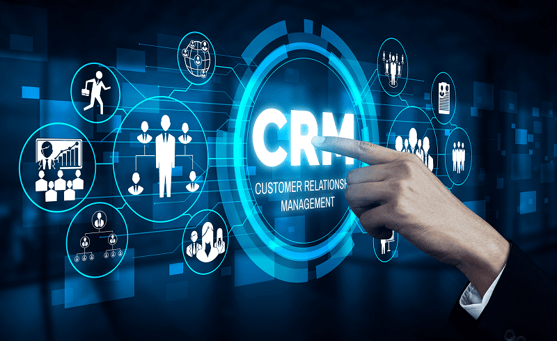 Hand pointing at CRM digital interface.